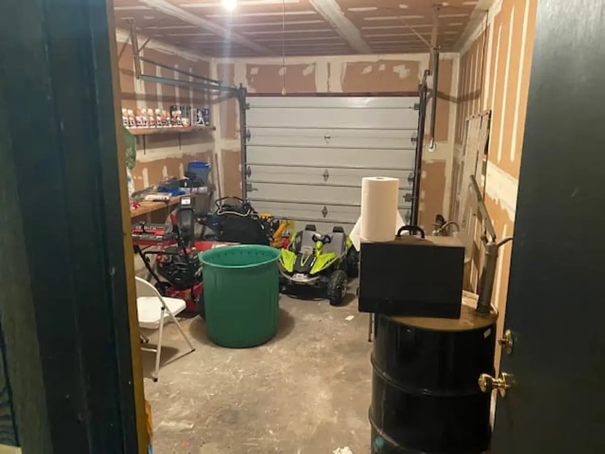 Selling a house with tenants in it in Ronkonkoma: garage filled with bins, tools and stored equipment