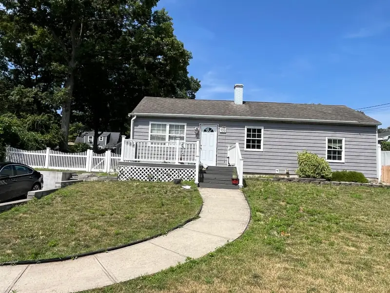 Gray ranch with a white porch rail and a curved front walk, Ronkonkoma, NY