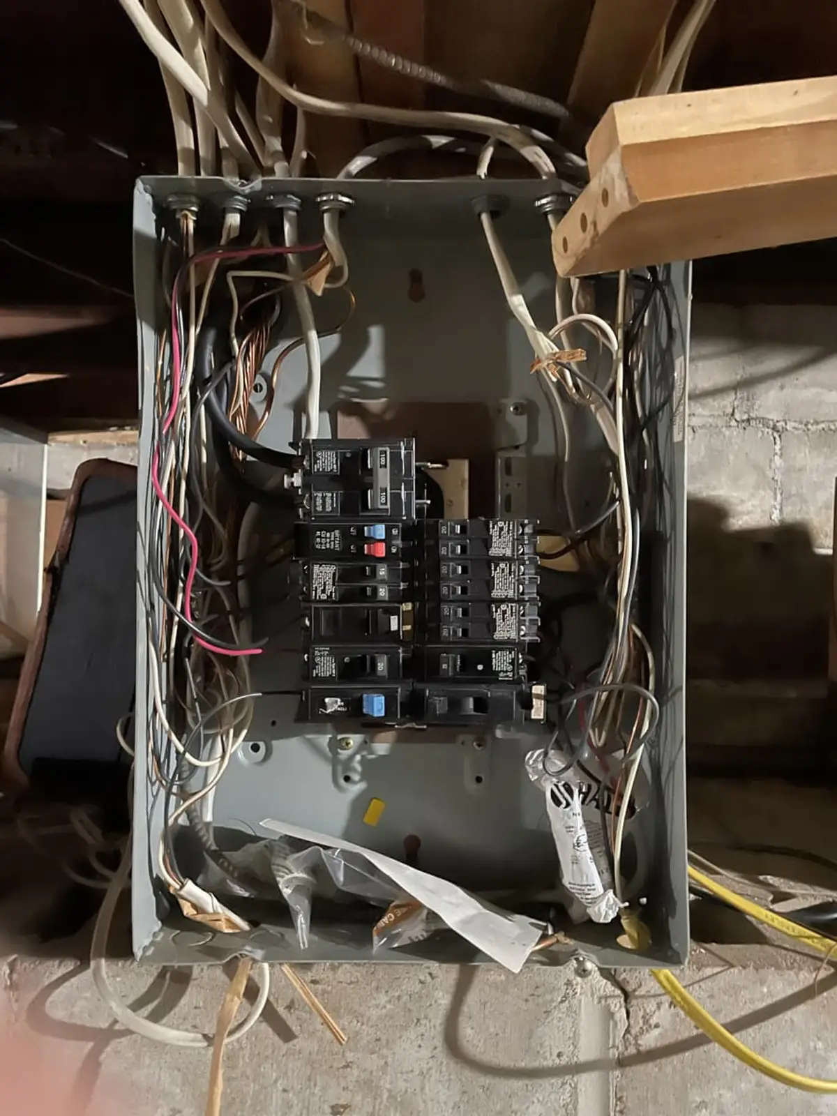 Selling a house with code violations in Ronkonkoma: open electrical panel with tangled, exposed wiring